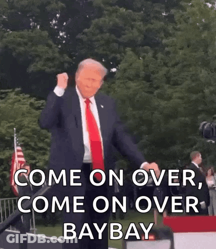 Man In Suit On Stage With Fist In Air Saying Come On Over Baybay GIF