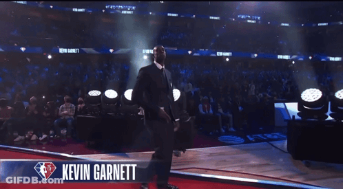 Man In Suit On Stage With Kevin Garnett GIF