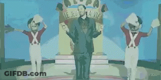 Man In Suit On Stage With Two Soldiers GIF