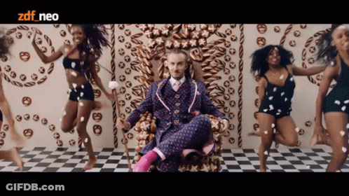 Man In Suit On Throne Surrounded By Dancing Women ZDF Neo GIF