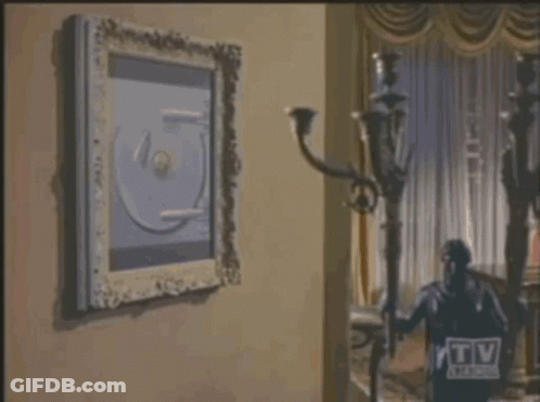 Man In Suit Opening Safe With TV Guide Logo GIF