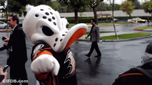Man In Suit Passing Duck Mascot GIF