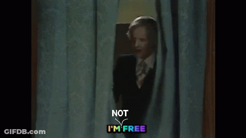 Man In Suit Peeking Behind Curtain Not I'm Free GIF