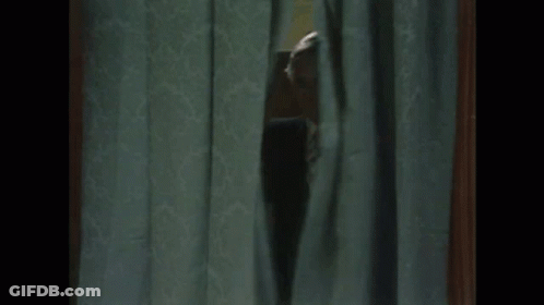 Man In Suit Peeking Through Curtain GIF