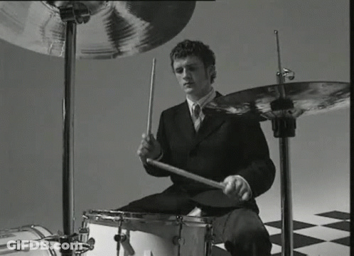 Man In Suit Playing Drums Black And White GIF