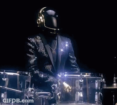 Man In Suit Playing Drums In Dark Room GIF