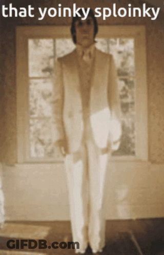 Man In Suit Playing Piano While Woman In Black Dress Dancing GIF