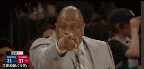 Man In Suit Pointing At Camera During Basketball Game GIF