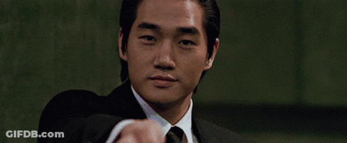 Man In Suit Pointing At Camera Green Background GIF
