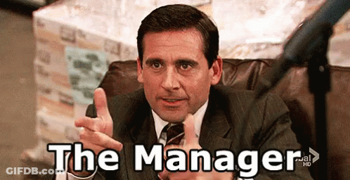 Man In Suit Pointing At Camera Saying The Manager GIF