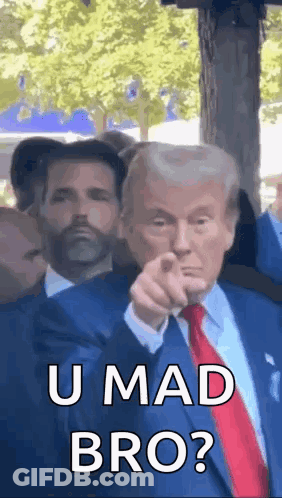 Man In Suit Pointing At Camera With Another Man Looking On GIF