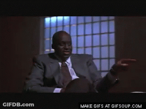 Man In Suit Pointing At Desk GIF