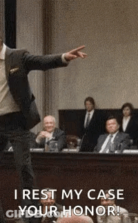 Man In Suit Pointing At Jury In Courtroom GIF
