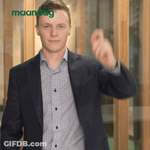 Man In Suit Pointing At Maandag Sign GIF