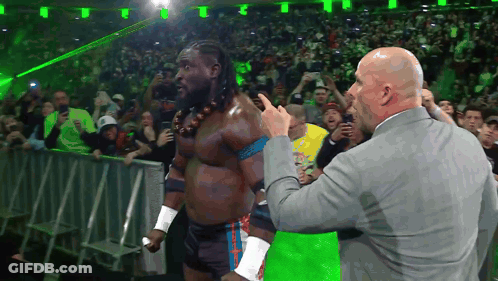 Man In Suit Pointing At Wrestler In Ring GIF