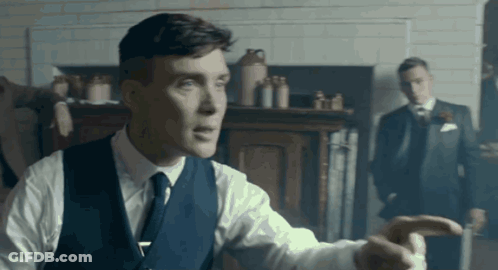 Man In Suit Pointing With Another Man Behind GIF