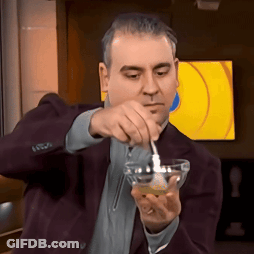 Man In Suit Pouring Into Small Bowl GIF