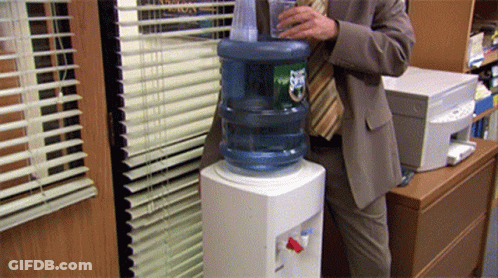 Man In Suit Pouring Water Bottle Ups GIF