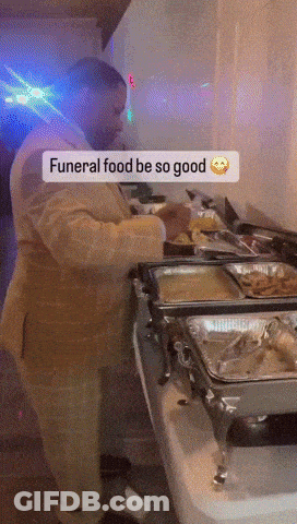 Man In Suit Preparing Food For Funeral GIF