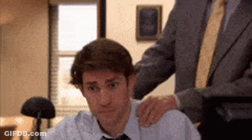 Man In Suit Puts Hand On Colleague's Shoulder GIF