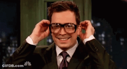 Man In Suit Putting On Glasses GIF