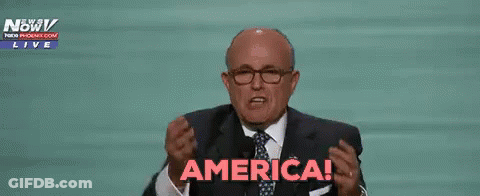 Man In Suit Raising Hands Saying America GIF