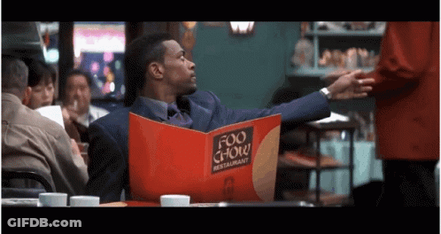 Man In Suit Reading Menu GIF