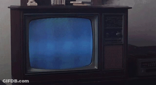 Man In Suit Reading Newspaper On Television GIF