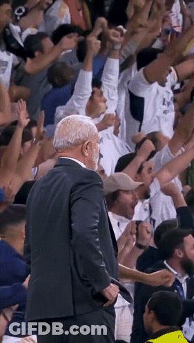 Man In Suit Reading Paper At Microphone GIF