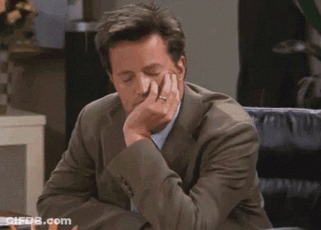 Man In Suit Resting Head On Hand GIF