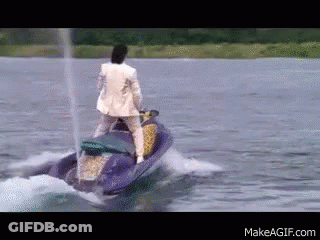Man In Suit Riding Jet Ski In Lake GIF