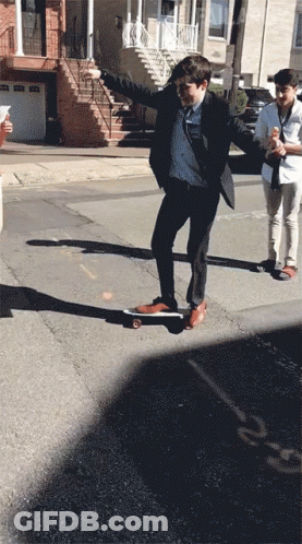 Man In Suit Riding Skateboard GIF