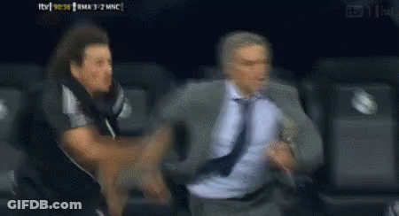 Man In Suit Running From Man In Black Shirt GIF