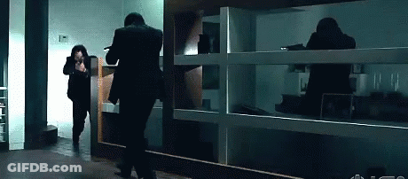Man In Suit Running In Dark Room GIF