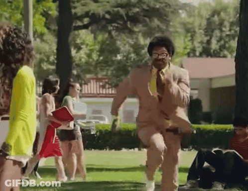 Man In Suit Running Through Park GIF