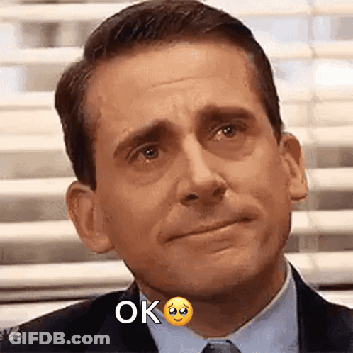 Man In Suit Sad Face Saying Ok GIF
