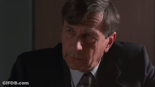 Man In Suit Saying America Couldn't Care Less GIF