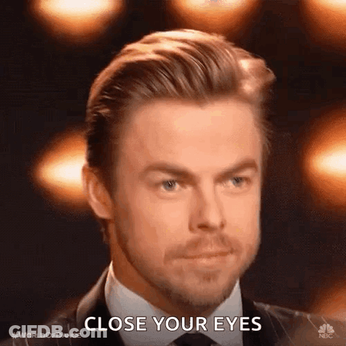 Man In Suit Saying Close Your Eyes GIF
