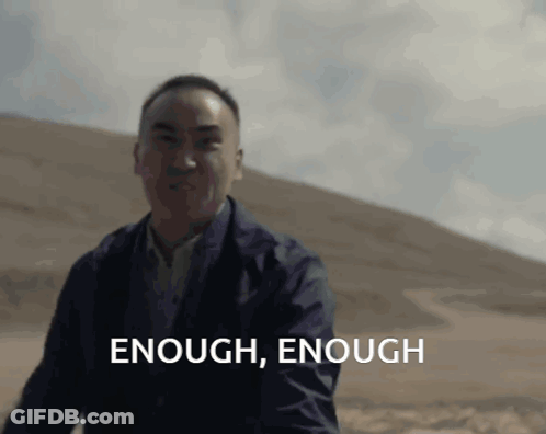 Man In Suit Saying Enough Enough In Front Of Hill GIF