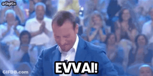 Man In Suit Saying Evvai To Crowd GIF
