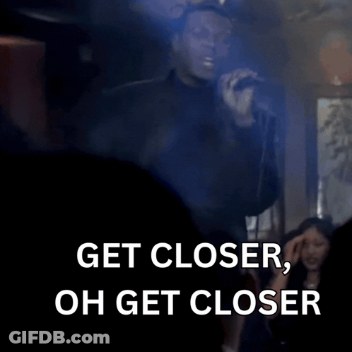 Man In Suit Saying Get Closer GIF