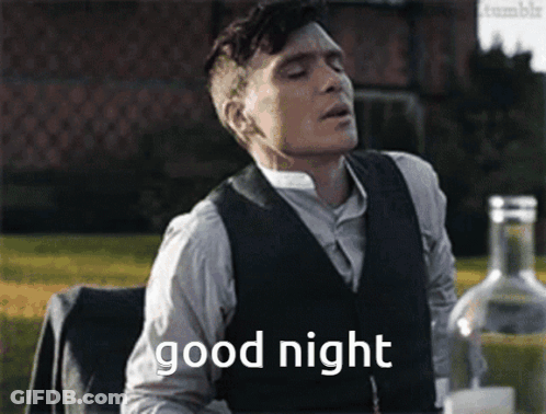 Man In Suit Saying Good Night At Table With Alcohol GIF