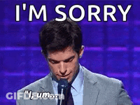 Man In Suit Saying I'm Sorry At Microphone GIF