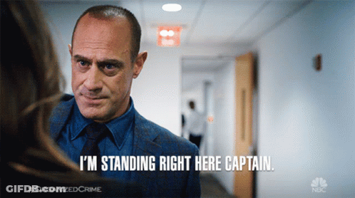 Man In Suit Saying I'm Standing Right Here Captain GIF