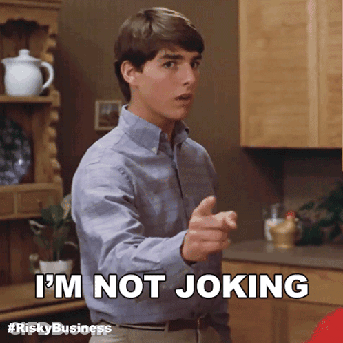 Man In Suit Saying It's Not A Joke Holding Paper GIF