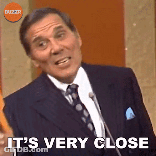 Man In Suit Saying It's Very Close At Microphone GIF