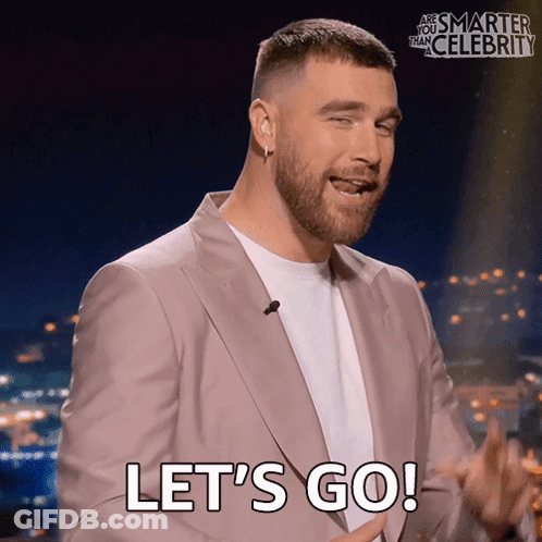 Man In Suit Saying Let's Go In Front Of Are You Smarter Than Celebrity Sign GIF