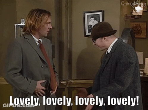 Man In Suit Saying Lovely To Man In Hat GIF