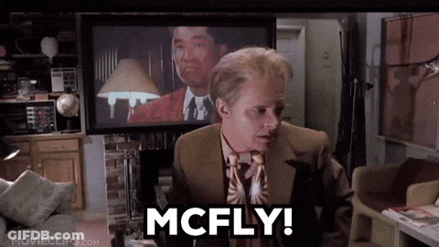 Man In Suit Saying McFly In Front Of TV GIF