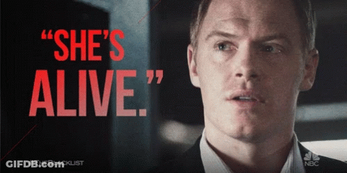 Man In Suit Saying She's Alive In Red GIF
